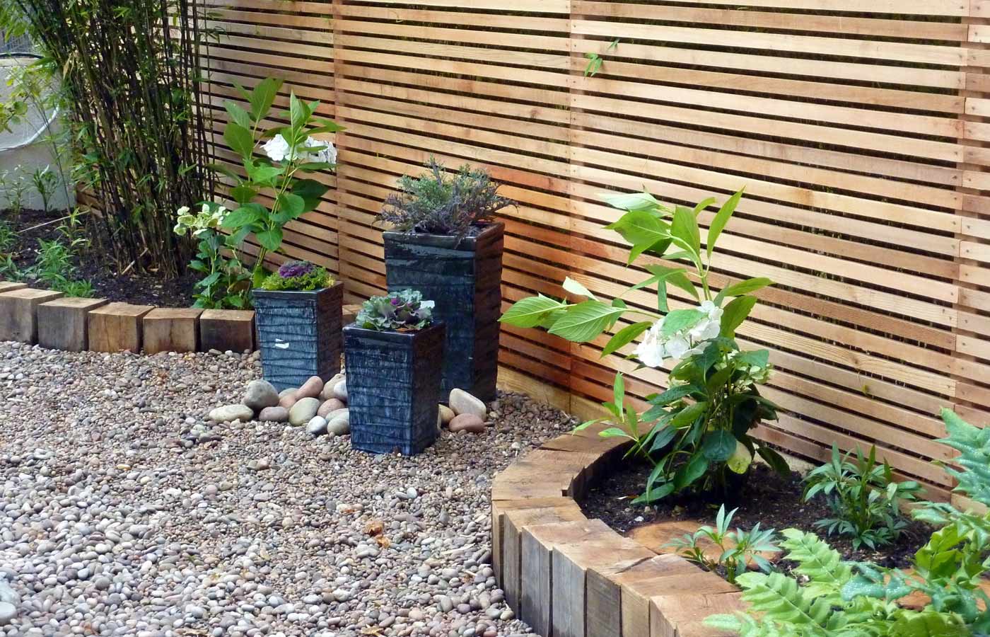 Rugged planters create an accent between planting areas