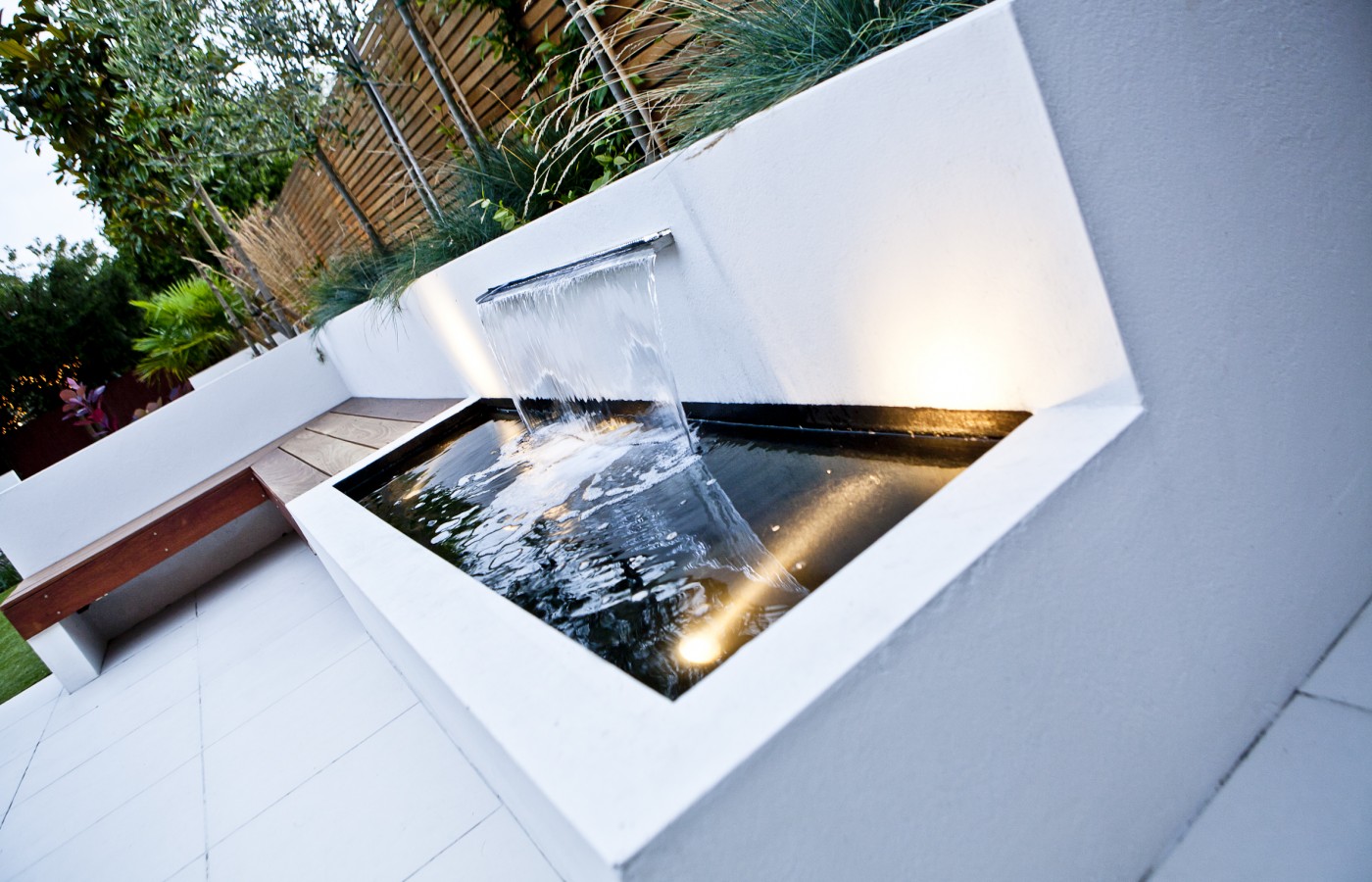Modern water feature in the white patio section of the garden