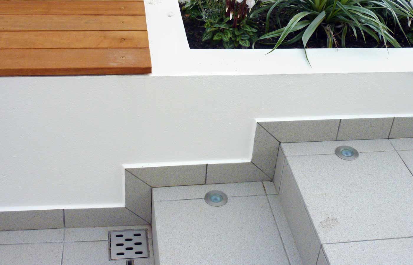 Rendered walls, recessed lighting and discreet drainage