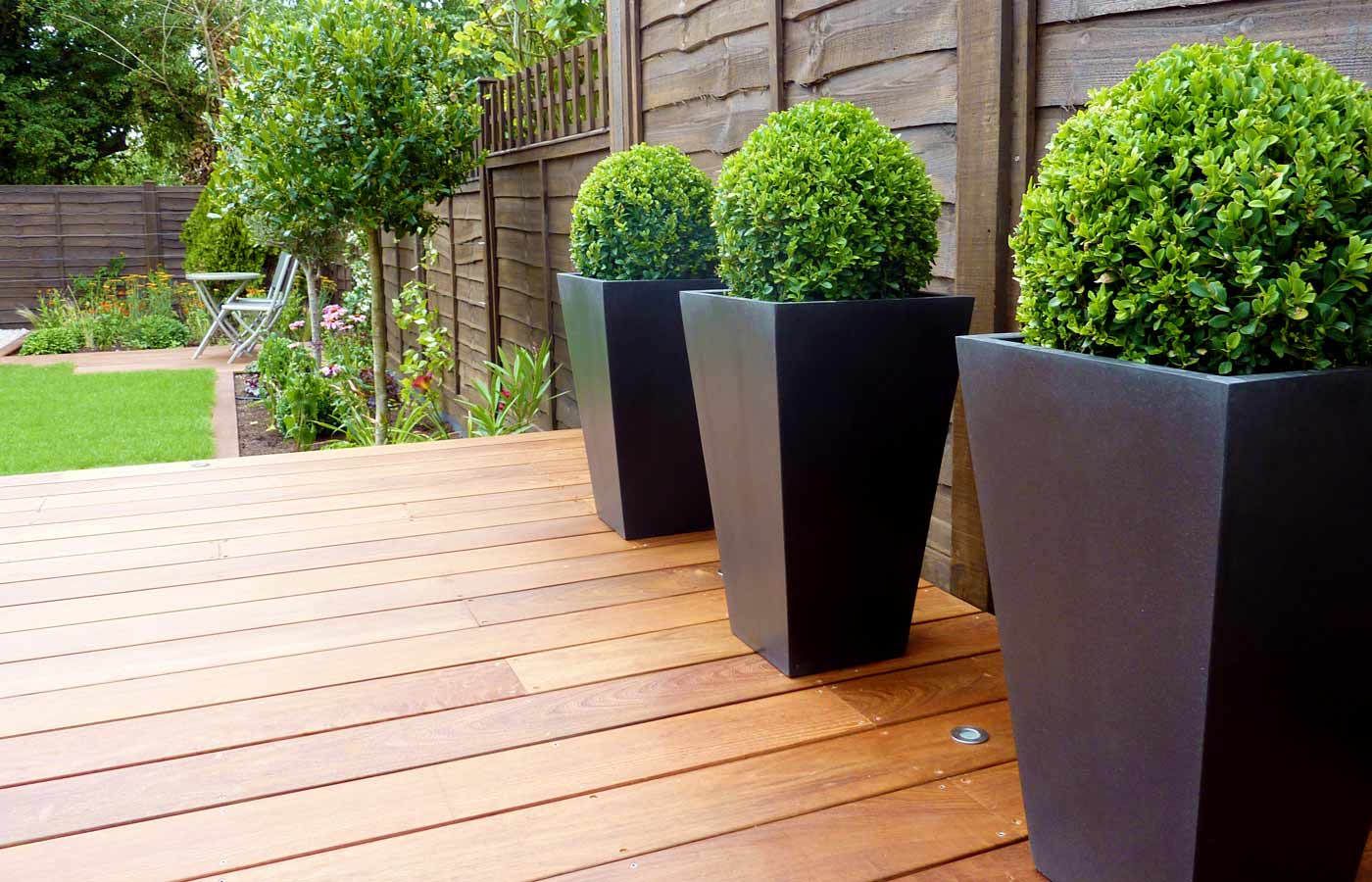 Planters with box balls in small garden